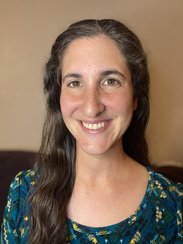 Elana Cohen, smiling, with long dark hair